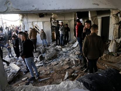 Palestinians look at the aftermath of an Israeli military raid on Jenin refugee camp in the West Bank on Wednesday, Nov. 29, 2023.