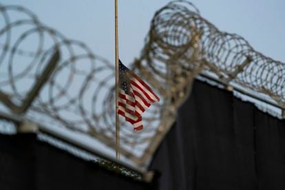 A flag flies at half-staff in honor of the U.S. service members and other victims killed in the terrorist attack in Kabul, Afghanistan, as seen from Camp Justice in Guantánamo Bay Naval Base, Cuba