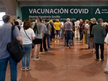 People wait in line to be vaccinated at the Estadio Olímpico in Seville on Thursday.