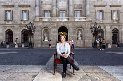 Ada Colau, sitting in front of Barcelona City Hall.