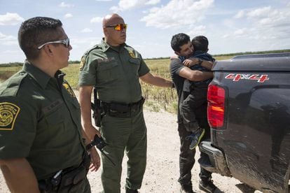 An immigrant embraces his son as he is arrested by Border Control in Roma, Texas.