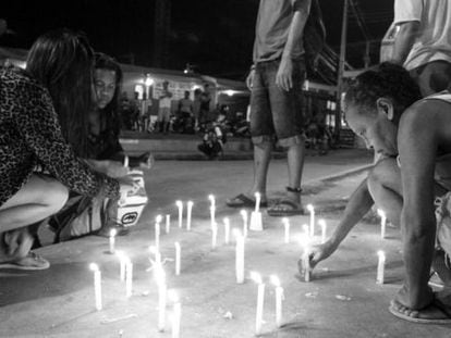 Residents of a building in Alemão, in Rio de Janeiro, light candles after the violent death of a child in April.