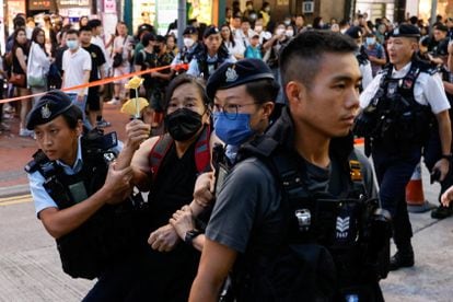Police detaining the activist Chan Po Ting in Hong Kong on Sunday.