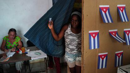 A voter walks out of a booth at a polling station during the new Family Code referendum in Havana, Cuba.