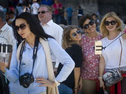 A group of tourists poses for selfies on Las Ramblas in Barcelona.