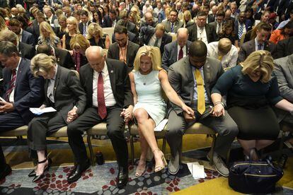 Reps. Louie Gohmert and Marjorie T. Greene pray at the America First Agenda convention.