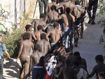 Sub-Saharan migrants captured after jumping into Melilla.