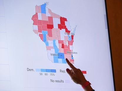 A supporter of Wisconsin Republican gubernatorial candidate Tim Michels points to the incoming state-wide data of the Wisconsin governor's race during an election night campaign event for Michels at the Italian Community Center, Nov. 8, 2022, in Milwaukee.