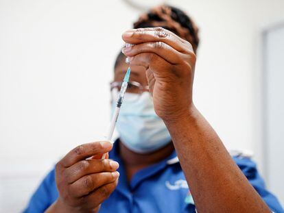 A nurse prepares a dose of a coronavirus disease vaccine.