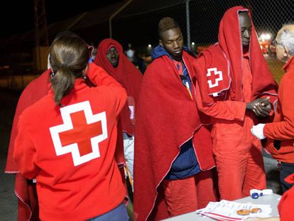 Red Cross staff tend to immigrants rescued from a dinghy in Motril.