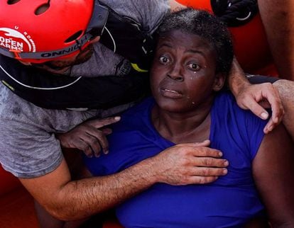 A crew member of NGO Proactiva Open Arms embraces the rescued woman.