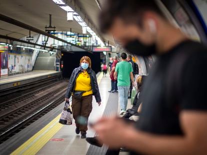 Commuters wear face masks in Madrid Metro. The measure will remain mandatory on public transportation.