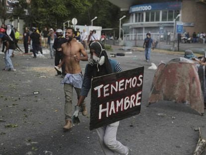 "We're hungry" reads a placard carried by a protester Monday in Caracas.