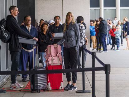 Marni Larsen and her son, Damon Rasmussen of Holladay, Utah, wait their turn in line hoping to snag her son's passport outside the Los Angeles Passport Agency at the Federal Building in Los Angeles on Wednesday, June 14, 2023.