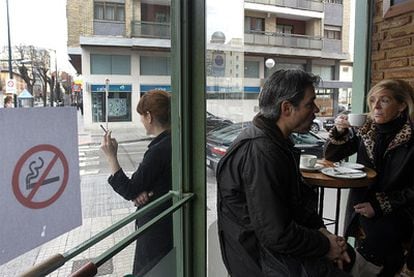 A woman smoking outside an establishment in Burgos after the new ban  was introduced.
