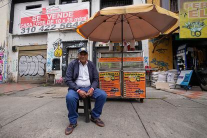 Ángel Bruges, from Venezuela, poses for a portrait at his empanada stand in Bogota, Colombia, Wednesday, February 22, 2023.