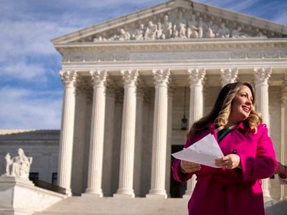 Lorie Smith, a Christian graphic artist and website designer in Colorado, prepares to speak to supporters outside the Supreme Court in Washington