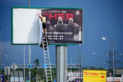 Removal of a Wagner poster under the slogan "Join Wagner" on a road in St. Petersburg, Russia, on Saturday. 