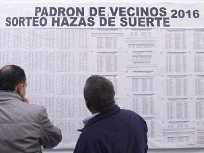 Locals check their names on the 'lucky lands' land raffle in Vejer de la Frontera.