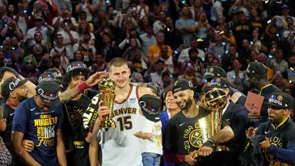 Nikola Jokic with his MVP trophy as the Nuggets celebrate victory in the NBA Finals.