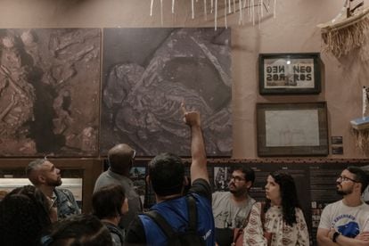 A tour guide explains an exhibit at the IPN museum in Rio de Janeiro