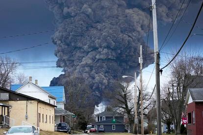 A black plume rises over East Palestine, Ohio, as a result of a controlled detonation of a portion of the derailed Norfolk Southern trains, on February 6, 2023.