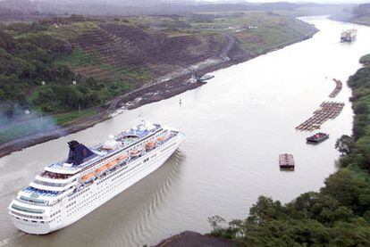 A cruise ship is towed through the Panama Canal.