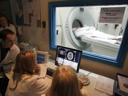 A group of physicians perform a scan to determine the extent of a patient's brain injury after a stroke.