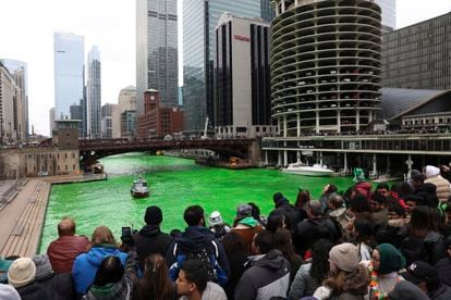 People observe while the Chicago River is dyed green, on March 11, 2023, to celebrate the upcoming St. Patrick's Day parade.