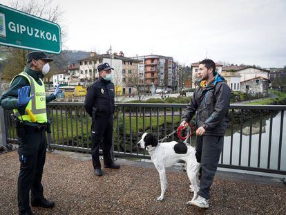 Police stopping a man from crossing the border between Spain and France on Tuesday.