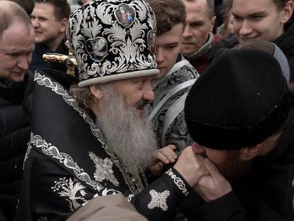 A senior priest of the Ukrainian Orthodox Church blesses parishioners in the Kyiv Pechersk Lavra monastery complex in Kyiv.