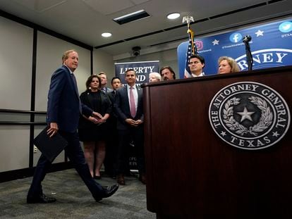Texas state Attorney General Ken Paxton, left, arrives with his staff to makes a statement at his office in Austin, Texas, Friday, May 26, 2023.