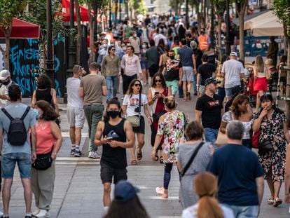 Dozens of people walk on Montera Street in Madrid, Spain.