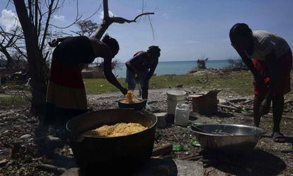 A group of women preparing food in the aftermath of Hurricane Matthew in Haiti.