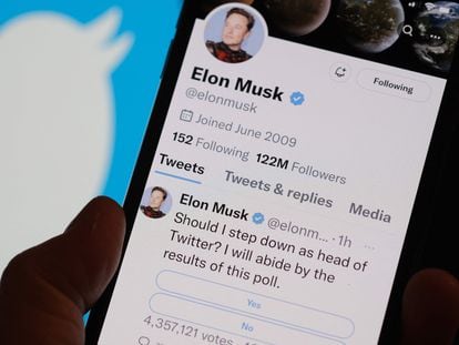 This photo illustration taken on December 18, 2022 in Los Angeles shows a phone displaying Elon Musk's Twitter page where he is conducting a survey about his future as the head of the company.