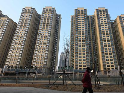 A woman walks past an Evergrande Group residential complex called Evergrande Palace in Beijing on January 29, 2024.