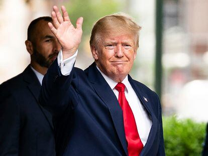 Former President Donald Trump waves as he departs Trump Tower, Wednesday, Aug. 10, 2022, in New York.
