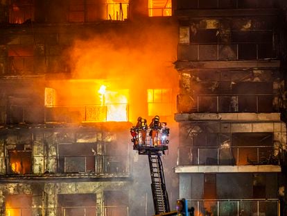 Firefighter work to put out a fire in a residential building in the Spanish city of Valencia on February 22.