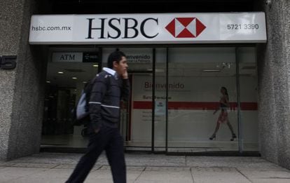 A man walks past a branch of British bank HSBC in Mexico City.