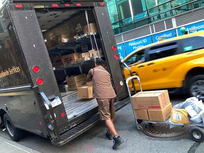 A United Parcel Service driver loads his truck, adjacent to a UPS Store, in New York, on May 11, 2023.