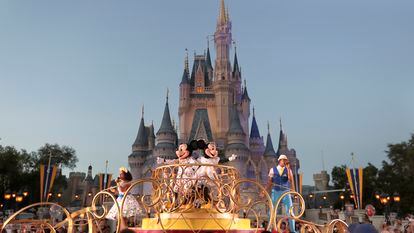 Mickey and Minnie Mouse perform during a parade as they pass by the Cinderella Castle at the Magic Kingdom theme park at Walt Disney World in Lake Buena Vista, Fla.