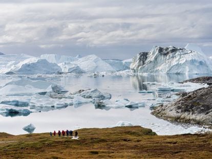 A group of tourists at the Ilulissat ice fjord, a place on the western coast of Greenland declared a UNESCO world heritage site.