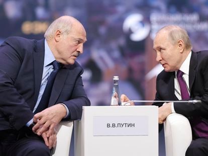 Russian President Vladimir Putin and Belarusian President Alexander Lukashenko talk to each other during the plenary session of the Eurasian Economic Forum in Moscow, Russia, on May 24, 2023.