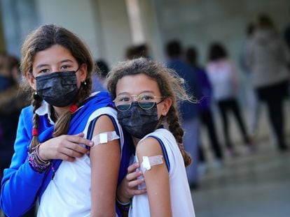 Two girls vaccinated in Santiago de Compostela in Spain’s Galicia region.