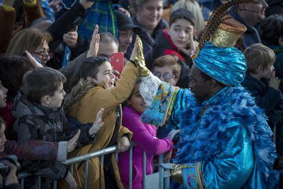 King Balthazar greets a boy during the parade in Barcelona.