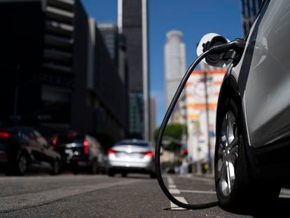 An electric vehicle is plugged into a charger in Los Angeles, on August 25, 2022.