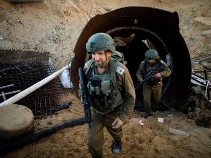 Israeli soldiers exit a tunnel near the border with Israel on December 15, 2023 in northern Gaza.