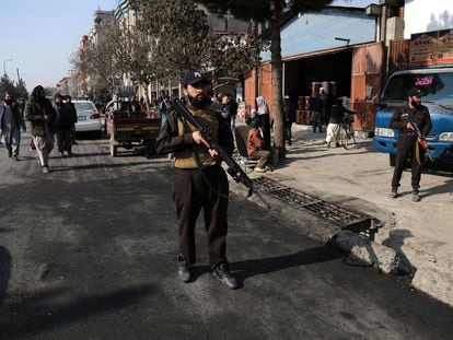 Taliban security personnel stand guard at the scene of a blast that hit a minibus in Kabul, Afghanistan, 07 January 2024.