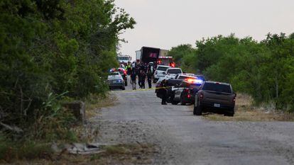 Law enforcement officers at the scene where 46 people were found dead inside a trailer truck in San Antonio, Texas,