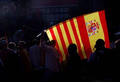 A protestor in Barcelona with the Spanish and Catalan flags.
